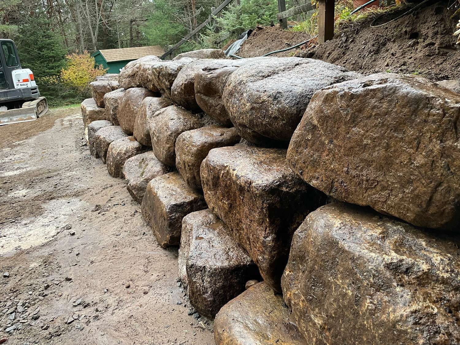 Natural boulder retaining wall on residential property