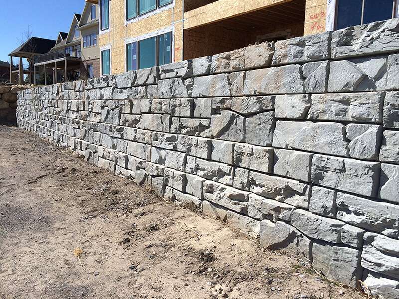 Engineered block retaining wall system for commercial site
