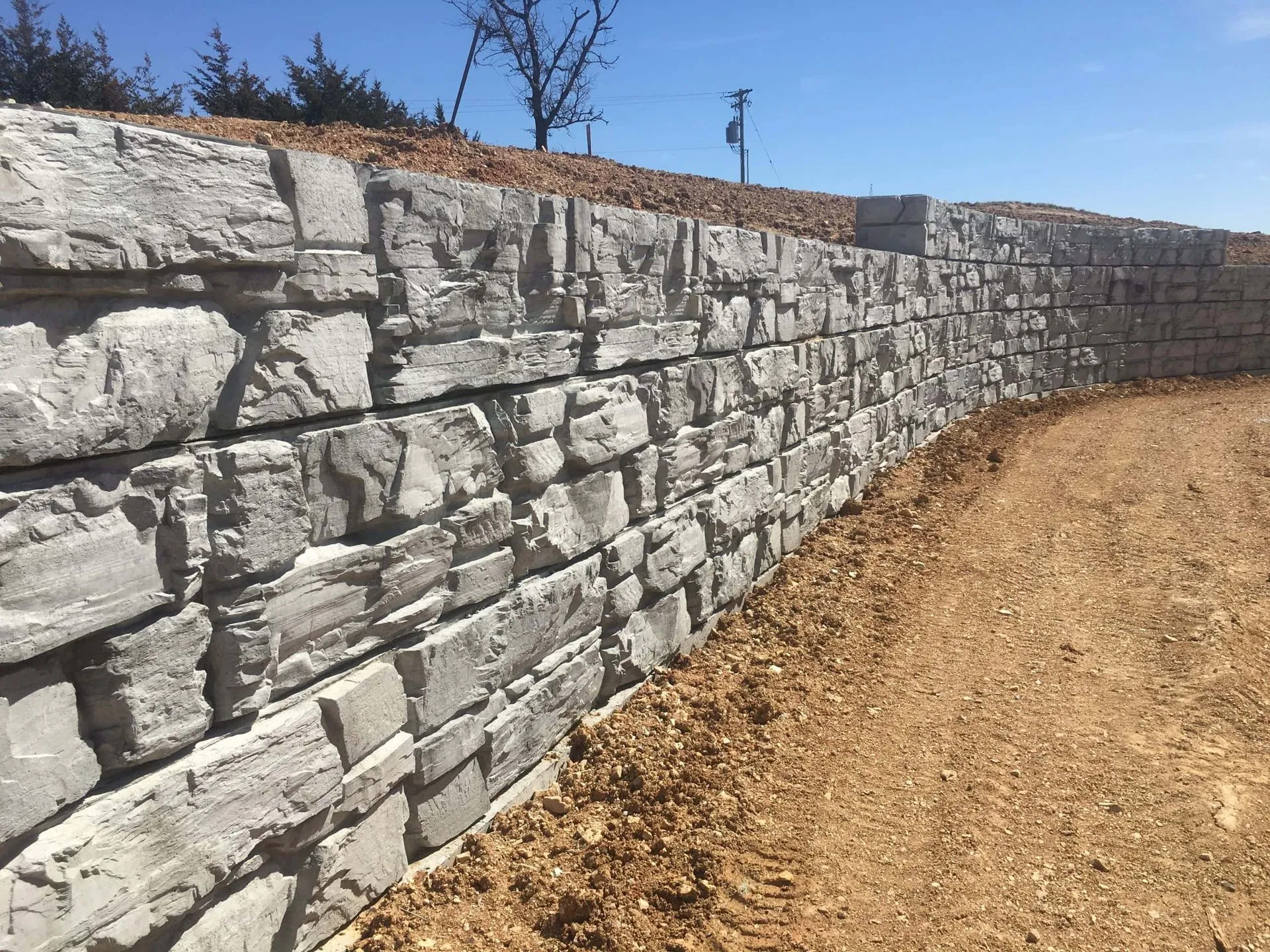 Natural stone retaining wall on hillside property